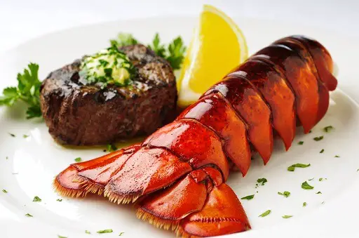 A combination of a lobster tail and a piece of steak