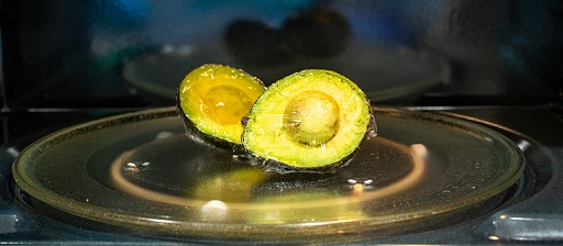 Divide the avocado in half and cover it with cling film before cooking in the microwave
